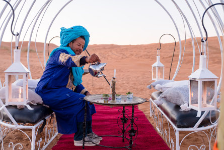 Our guy, Hakim, serving Moroccan tea in our Erg Chebbi Luxury Desert Camp Merzouga.jpg